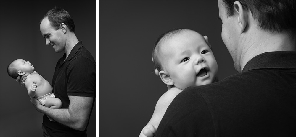 Father holding newborn baby boy in studio photography session in Sydney