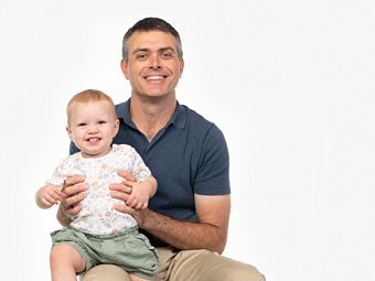Dad & toddler sitting in Coogee Kids photo session with white studio background