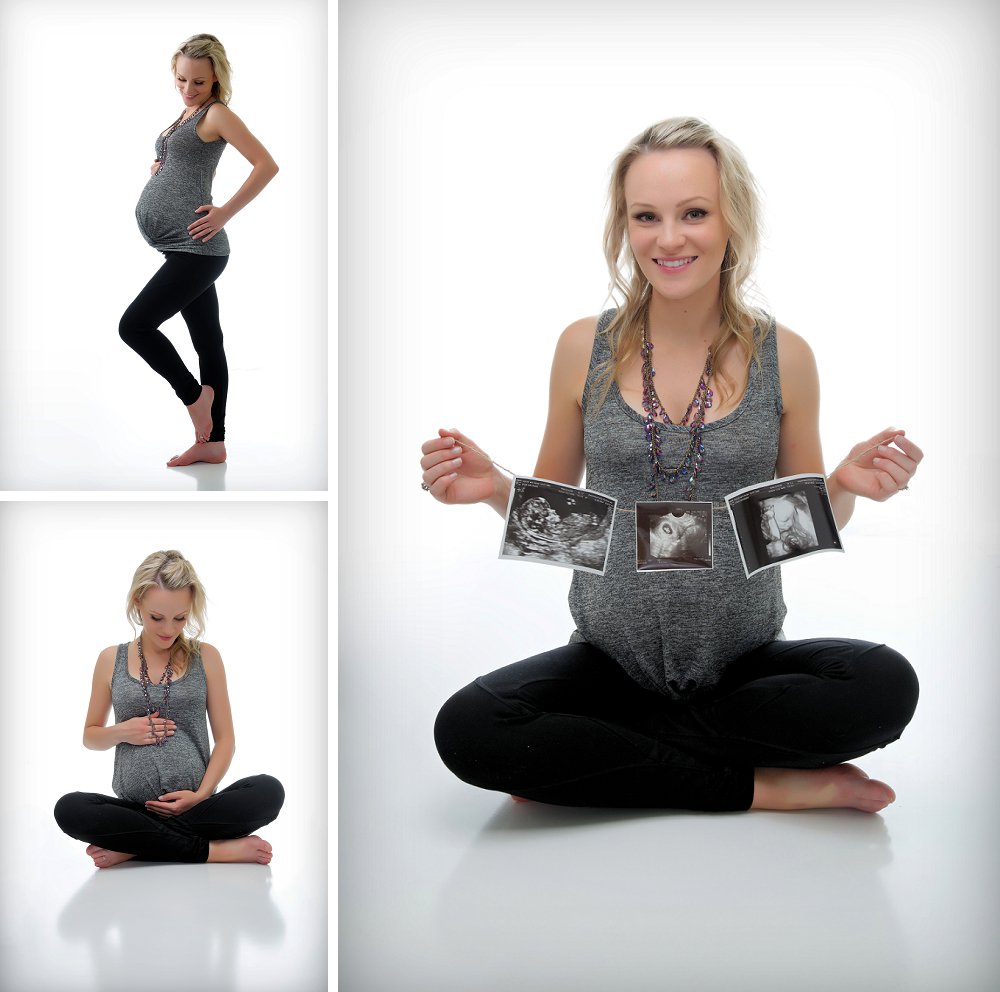 Pregnant blonde woman sitting cross legged in studio with ultrasounds