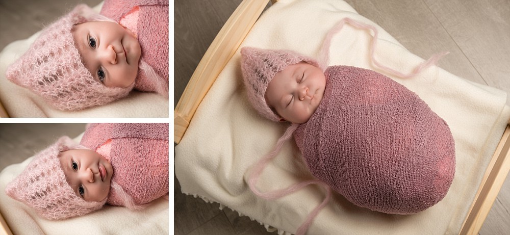 Newborn baby girl in pink wrap and bonnet in bed in Sydney studio