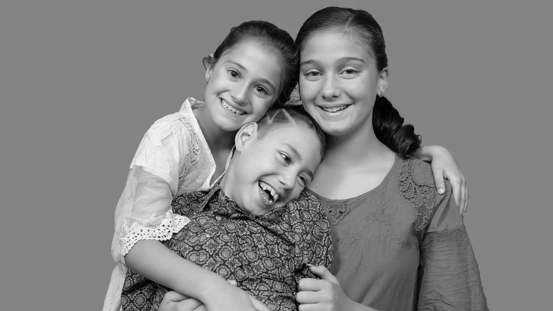 Two sisters and a brother in family photoshoot