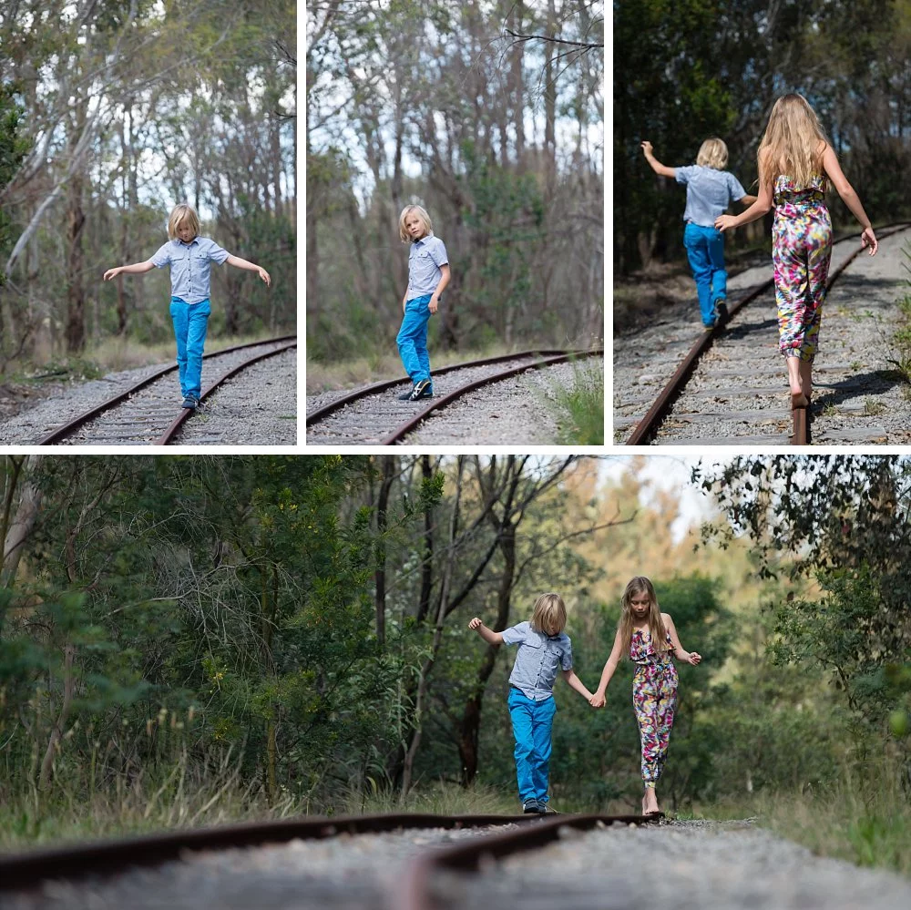 Boy and girl walking balancing on abandoned tracks at Sydney Olympic Park