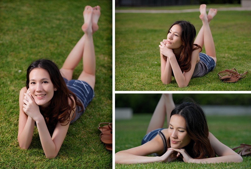 Young woman lying on grass smiling at camera