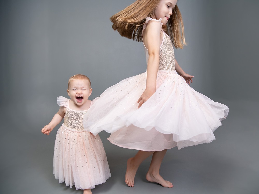 Sisters dancing and laughing in photo studio Sydney
