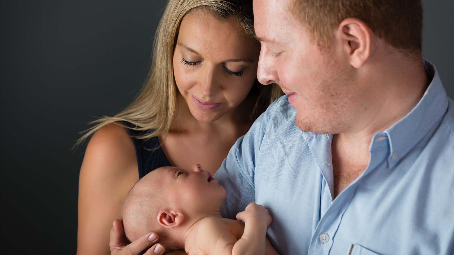 Caucasian couple with newborn baby in Sydney photography studio